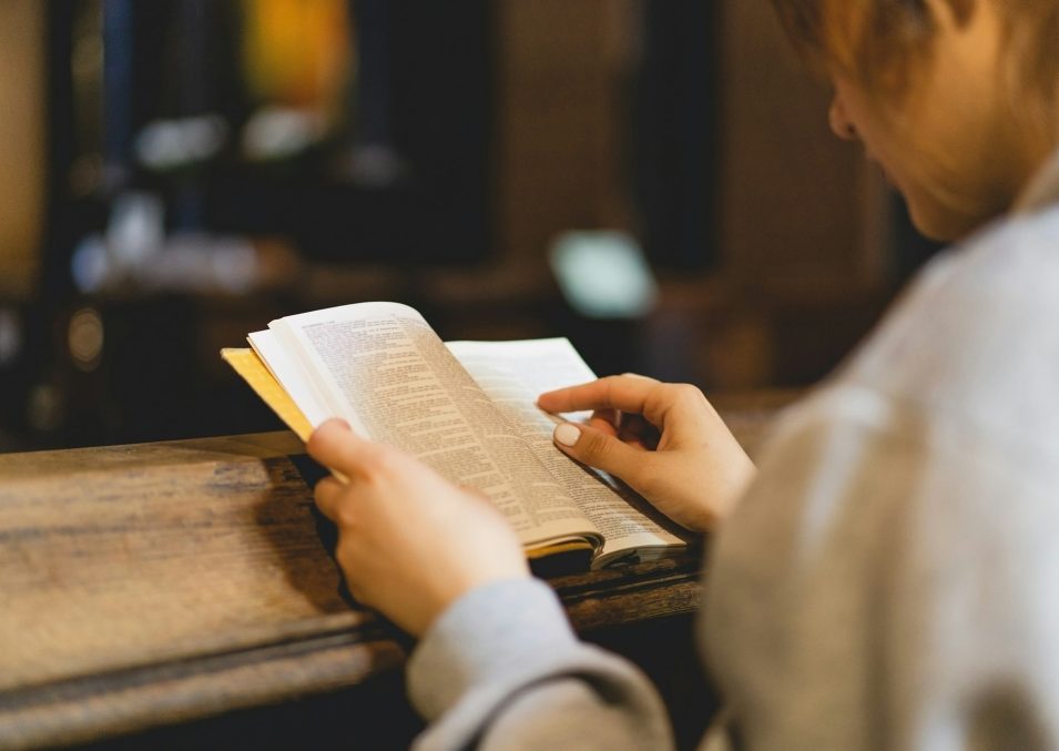 Christian woman reading bible in an ancient Catholic temple. Reading the Holy Bible in temple